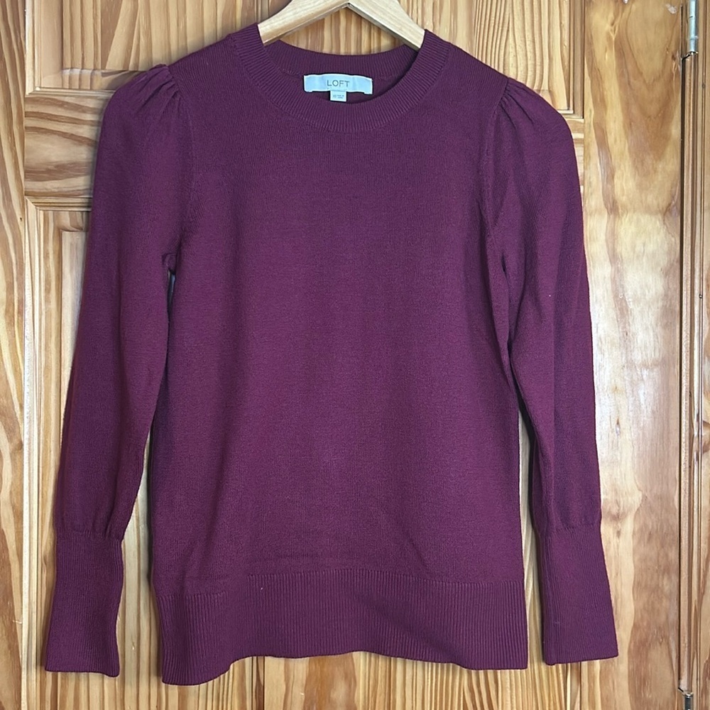 Loft sweater. Women’s size extra small. Maroon in color with a ruffled sleeve.